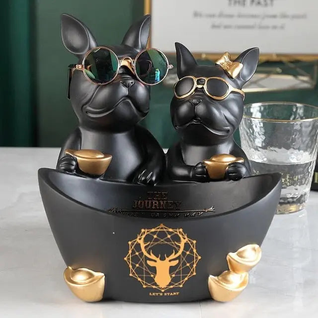 Decorative figurine of two dogs in sunglasses with a bowl on a table.
