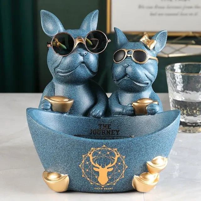 Two blue dog figurines with sunglasses on a boat-shaped platform with 'The Journey' text.