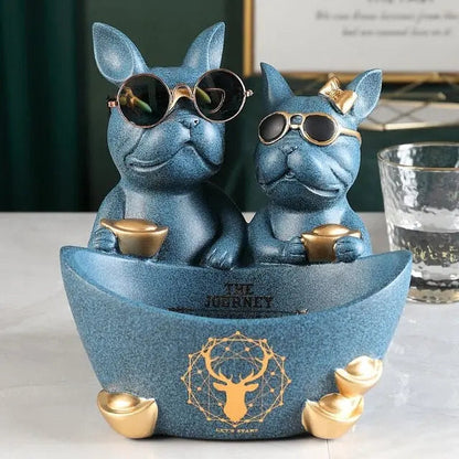 Two blue dog figurines with sunglasses on a boat-shaped platform with 'The Journey' text.