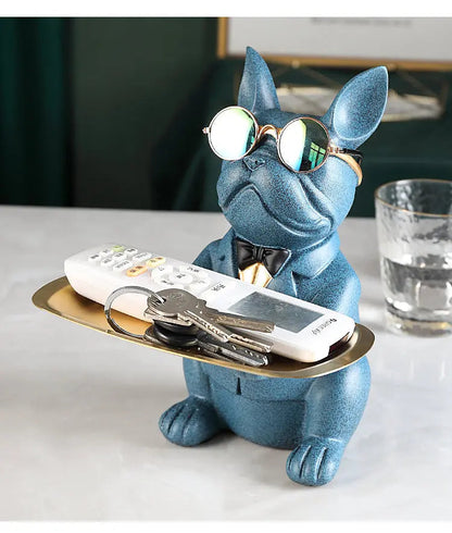 Blue dog-shaped holder with a tray on a white surface