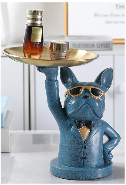 Blue dog figurine holding a gold tray with drinks in a home setting