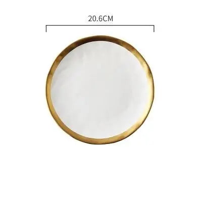 Round white plate with gold rim and measurement label on a white background
