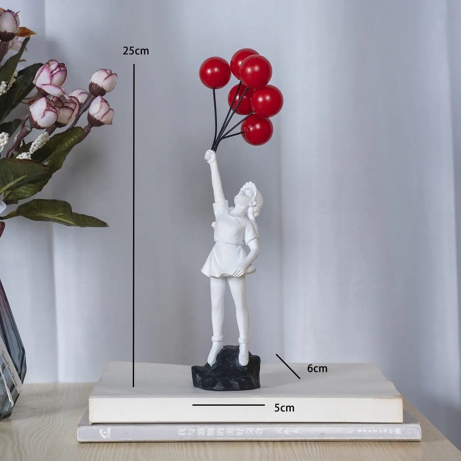White statue of a girl holding red balloons with measurements on a light gray background
