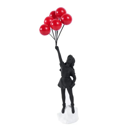 Black figurine holding red balloons on a white background