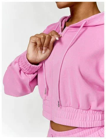 Person wearing a pink hoodie with a white background