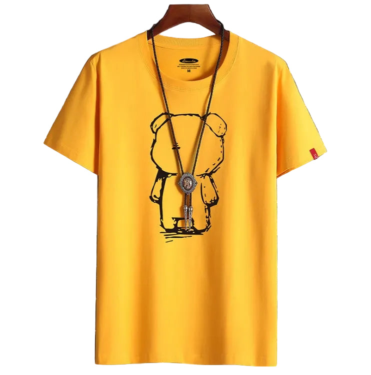 Yellow t-shirt with a bear graphic on a hanger against a tiled wall background
