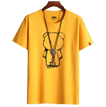 Yellow t-shirt with a bear graphic on a hanger against a tiled wall background