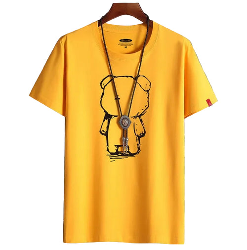 Yellow t-shirt with a bear graphic on a hanger against a tiled wall background