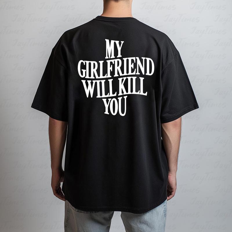 Black t-shirt with white text 'MY GIRLFRIEND WILL KILL YOU' on the back, worn by a person against a plain background.