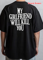 Black t-shirt with white text 'MY GIRLFRIEND WILL KILL YOU' on the back, worn by a person.