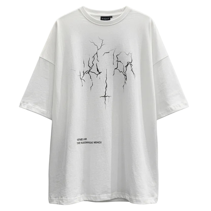 Person wearing a white oversized t-shirt with black graphics against a plain wall.