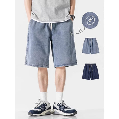 Person wearing blue denim shorts with additional shorts displayed below on a white background