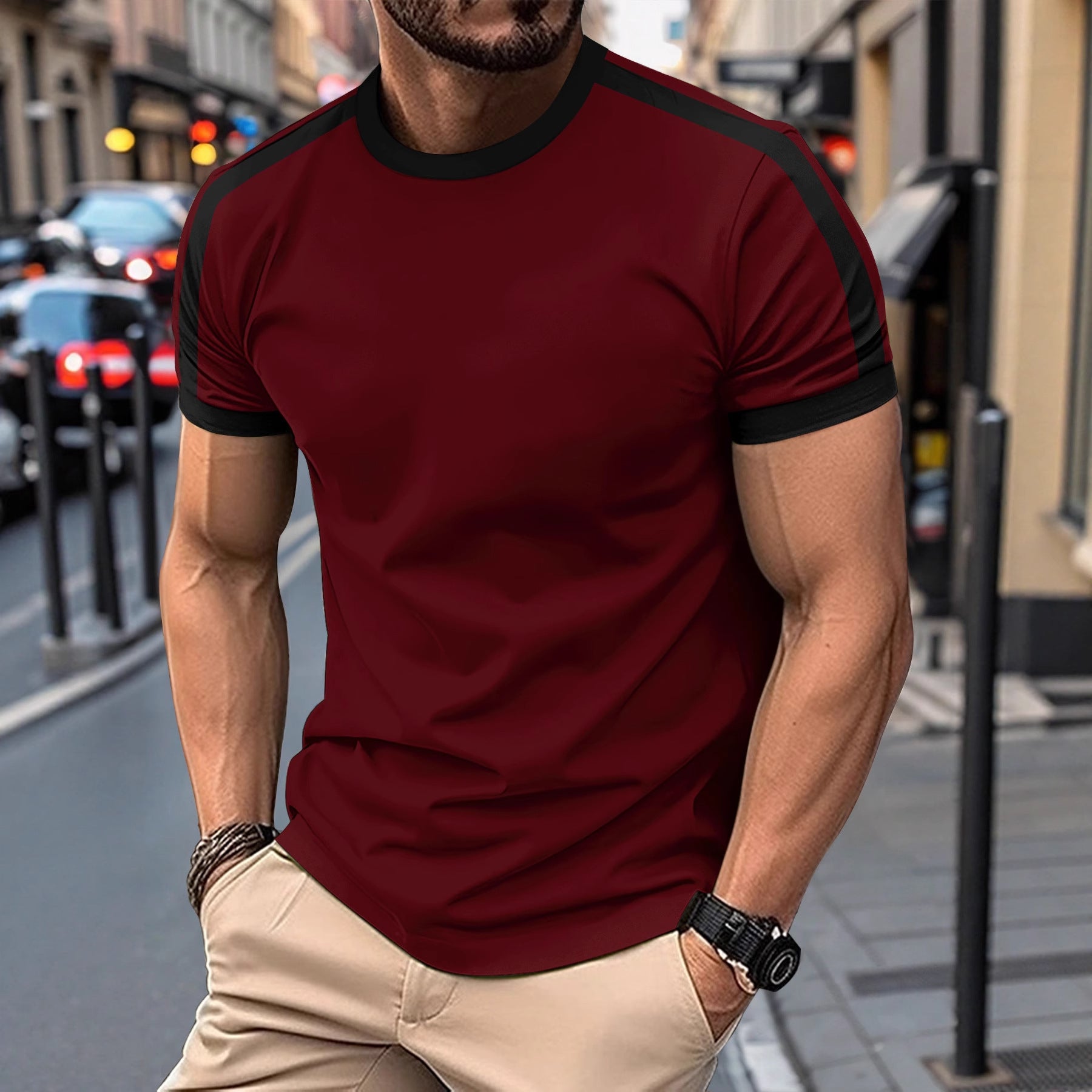 Man wearing a red and black t-shirt on a city street