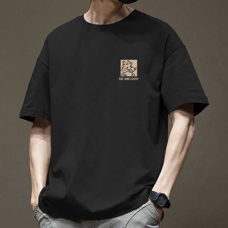 Person wearing a black t-shirt with a logo and text on a brown background