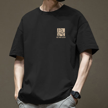 Person wearing a black t-shirt with a logo and text on a brown background