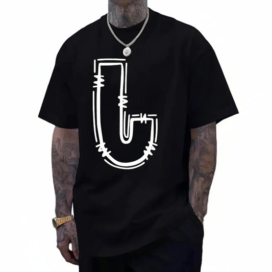 Person wearing a black t-shirt with a white graphic design against a gray wall.