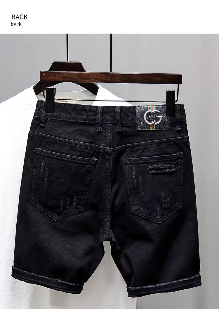Black denim shorts on a hanger against a white background