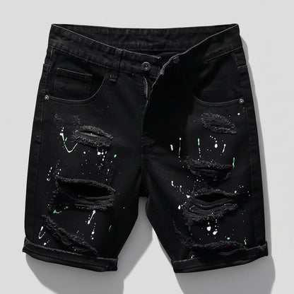 Black distressed denim shorts on a white background