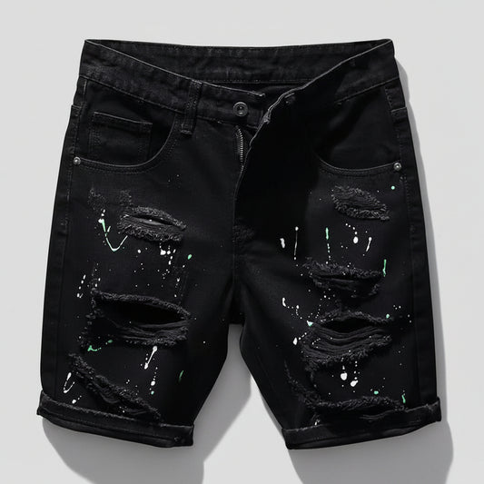 Black distressed denim shorts on a white background