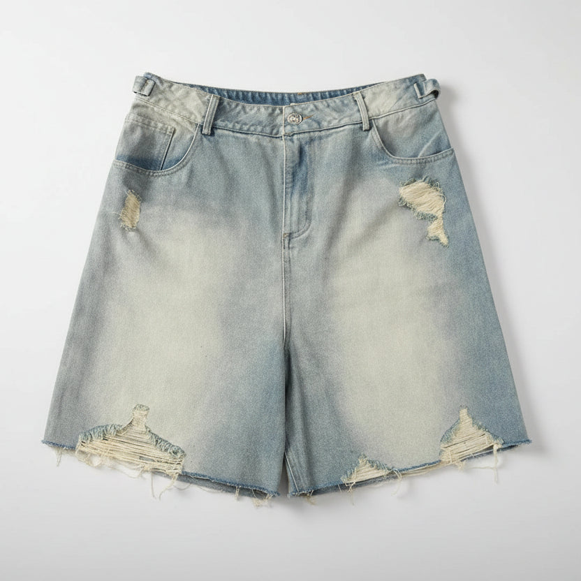 Distressed denim shorts on a white background