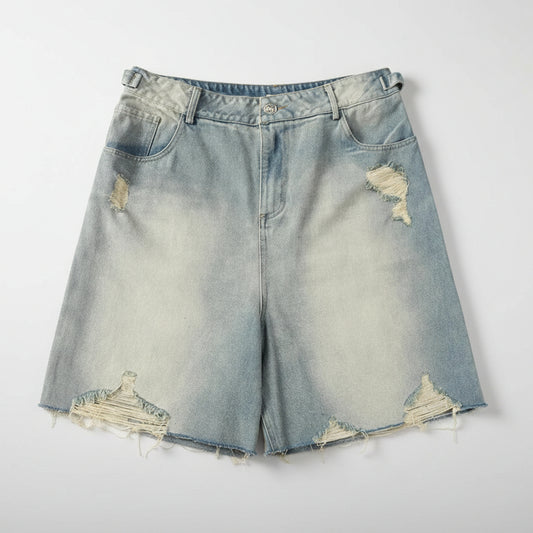 Distressed denim shorts on a white background