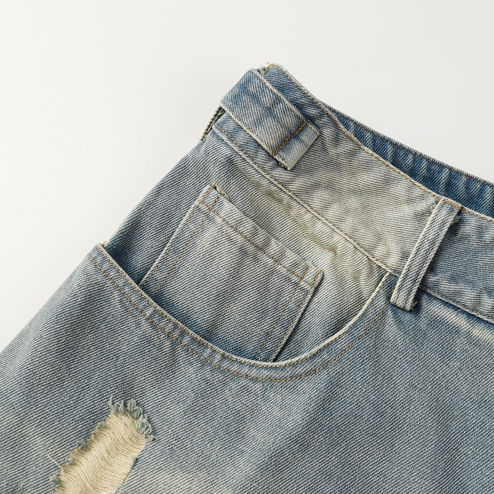 Close-up of a pair of light blue denim shorts with a white background