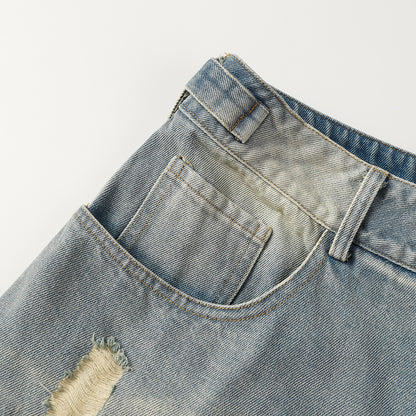 Close-up of a pair of light blue denim shorts with a white background