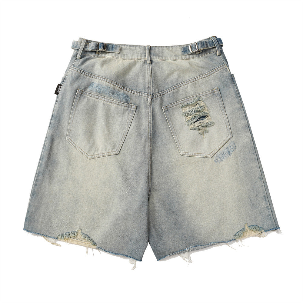 Light blue denim shorts with distressed details on a white background