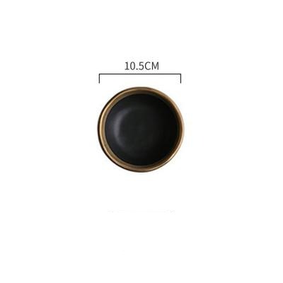 Black circular object with gold rim and measurement label on a white background