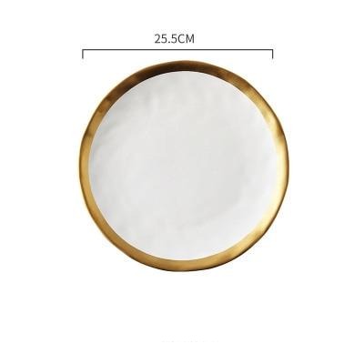 Round white plate with gold rim and measurement label on a white background